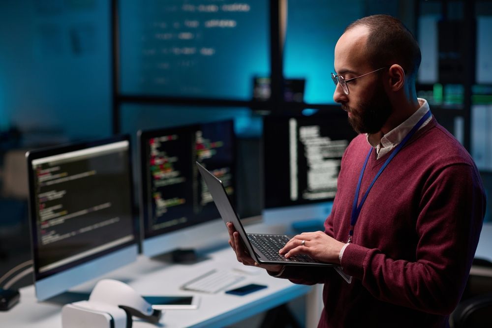 Person Coding on a Laptop in a Modern Office — Compago Technologies In Cambridge, TAS