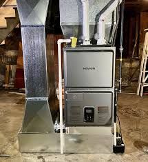 Hand adjusting controls on a wall-mounted gas water heater with exposed pipes and valves