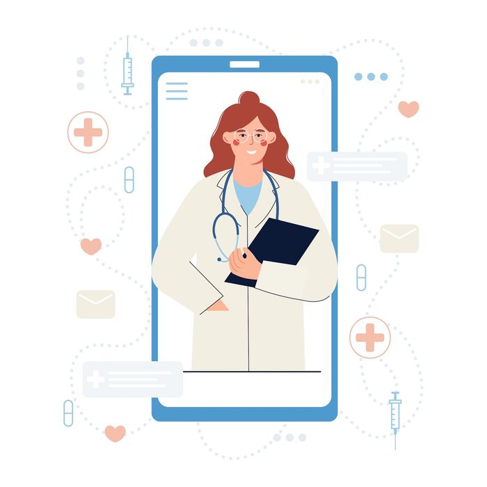 A female doctor is standing in front of a cell phone holding a clipboard.