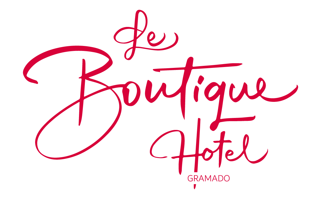 Um logotipo vermelho para o hotel boutique em um fundo branco
