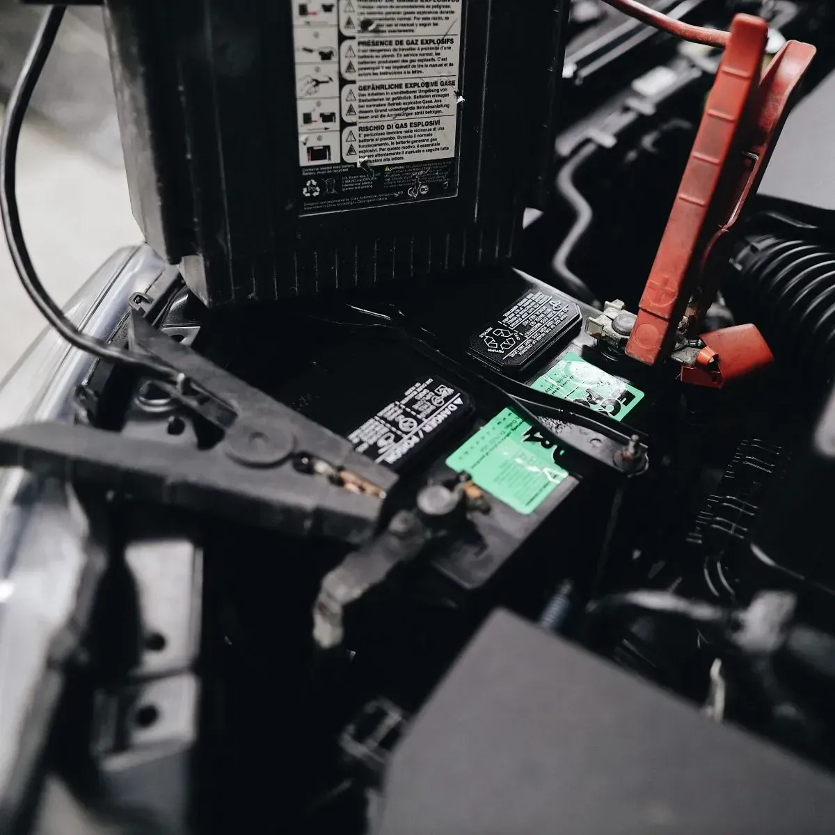 Close-up of exposed electronics with black circuit boards, green components, and red cables inside a device.