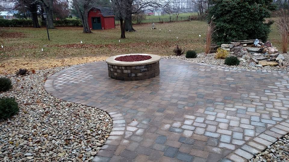 Custom paver patio with a built-in stone fire pit.