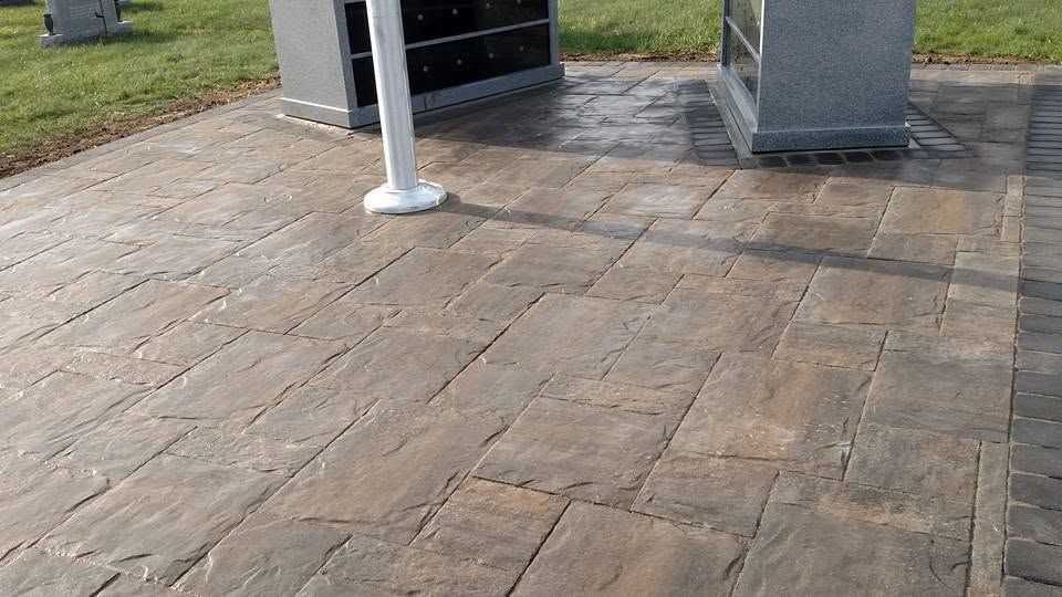 Detailed view of a textured stamped concrete patio walkway with a large-format stone pattern