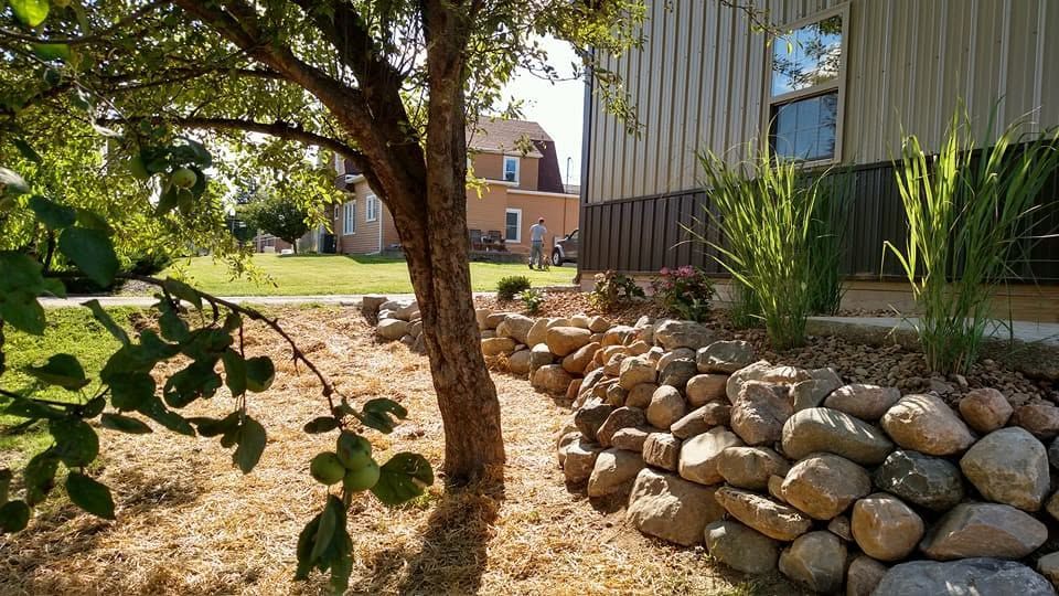 Wet brick paver patio beside a residential building entrance