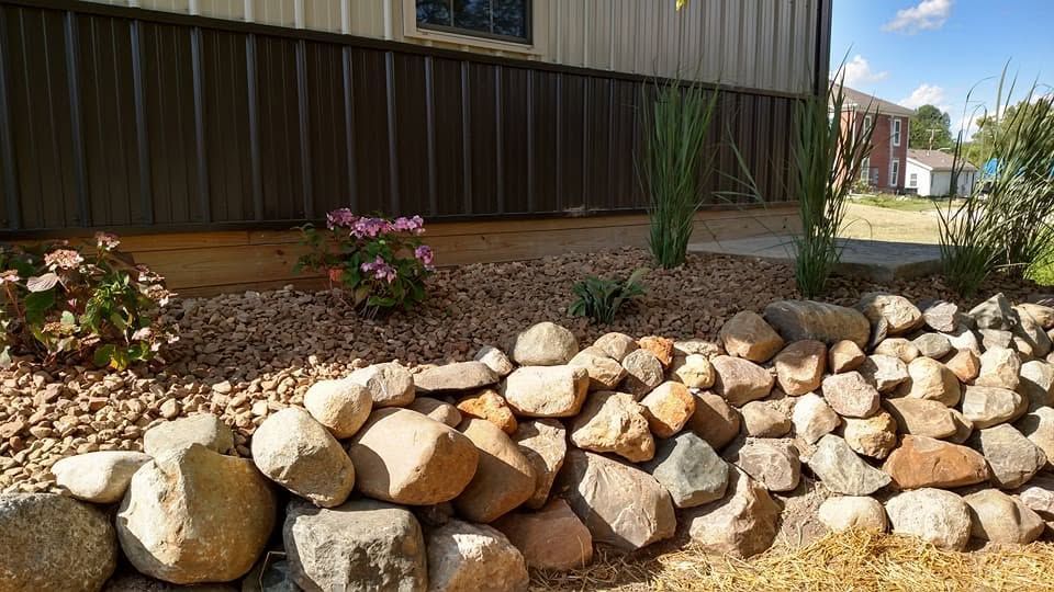 Concrete patio beside a wooden gazebo at a completed landscaping project