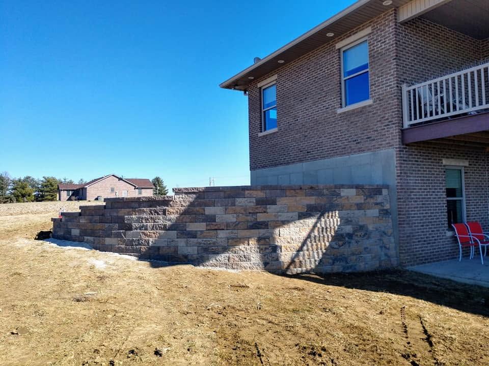 Structural block retaining wall built on a sloped residential property in Indiana.