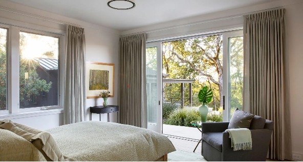 Modern bedroom addition with large windows and natural light.