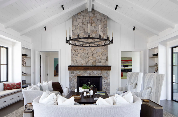 A bright and modern bonus room addition featuring large windows and comfortable seating.