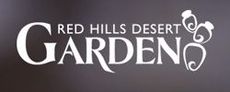 The logo for red hills desert gardens is white on a gray background.