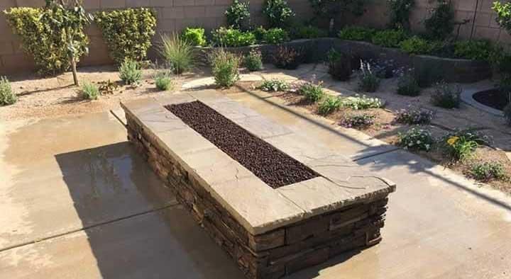 There is a fire pit in the middle of the patio.