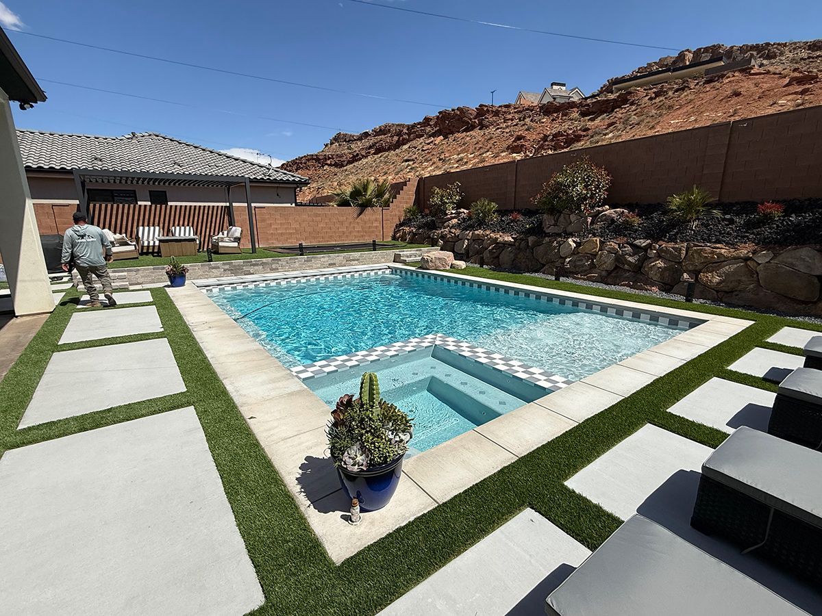 A large swimming pool in a backyard with a house in the background.