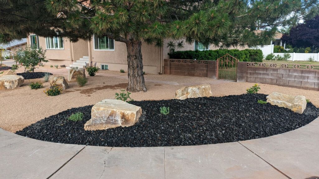 A garden with rocks and gravel in front of a house