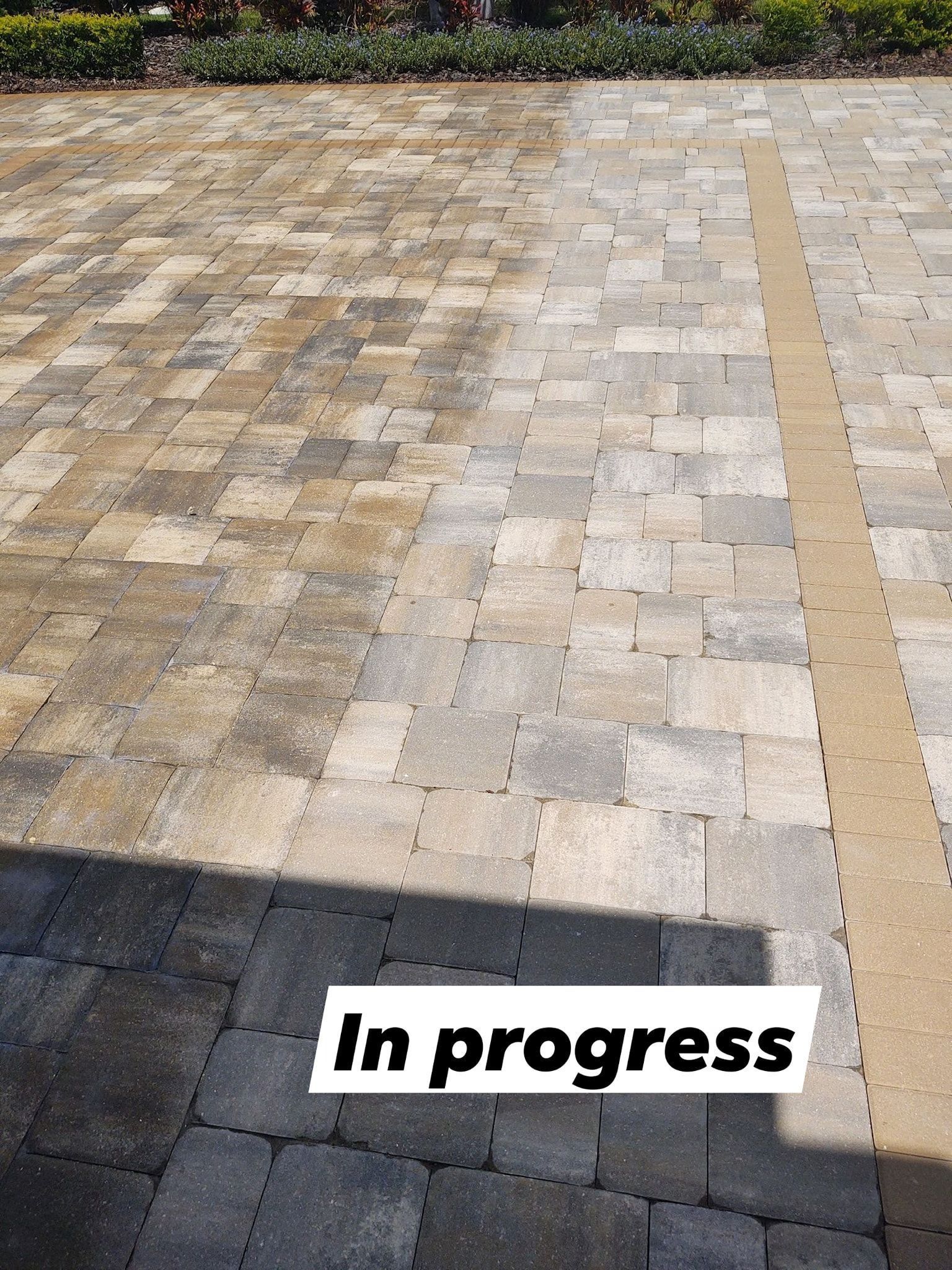 Paved walkway with tan and gray stones, marked “In progress” near the bottom.