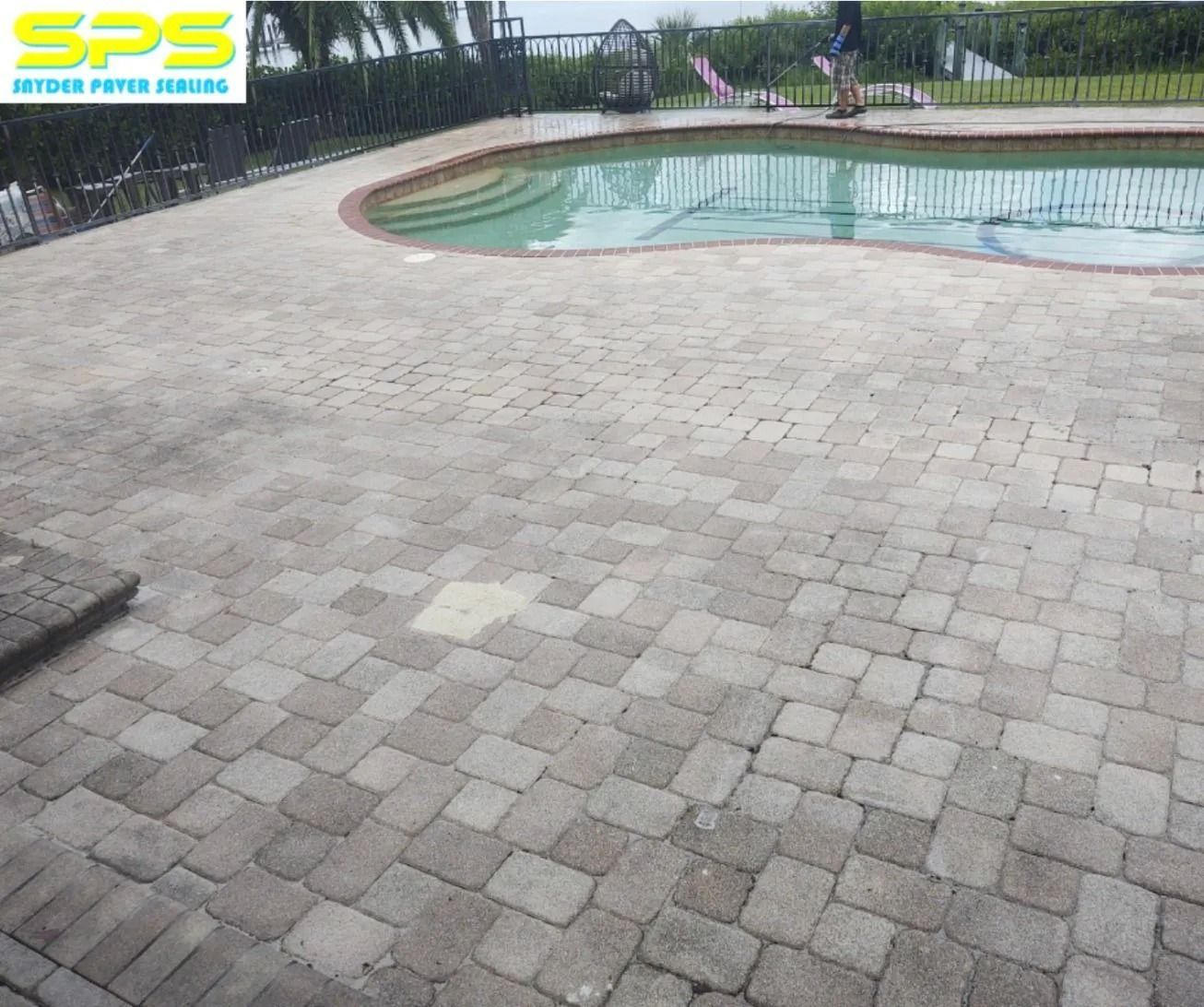 Paved courtyard beside a small curved pool, with SPS logo watermark in the top-left corner.
