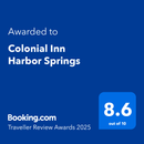 Booking.com Traveller Review Awards 2025 badge for Colonial Inn Harbor Springs, showing 8.6 out of 10 on blue background