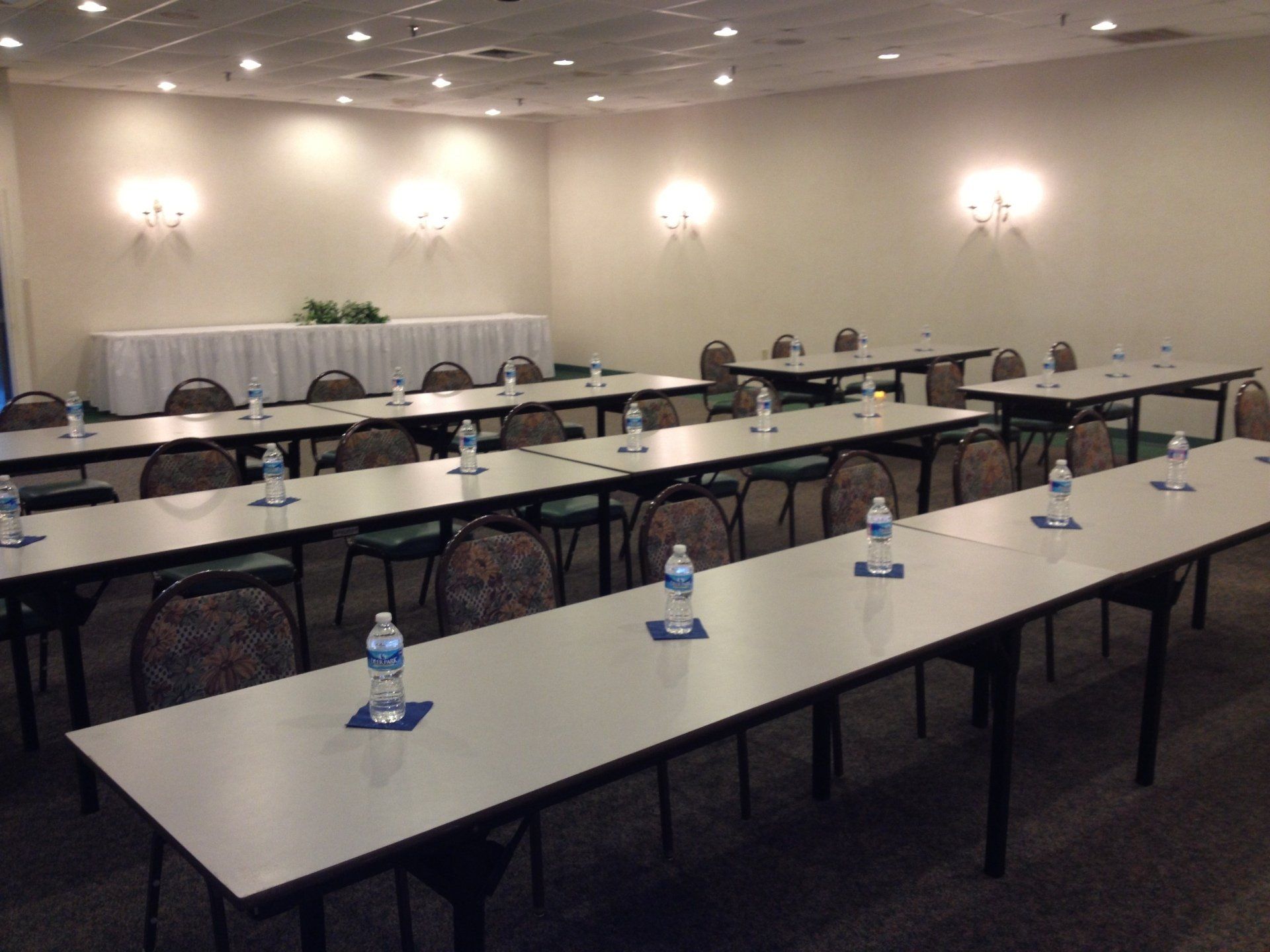 A conference room with tables and chairs set up for a meeting