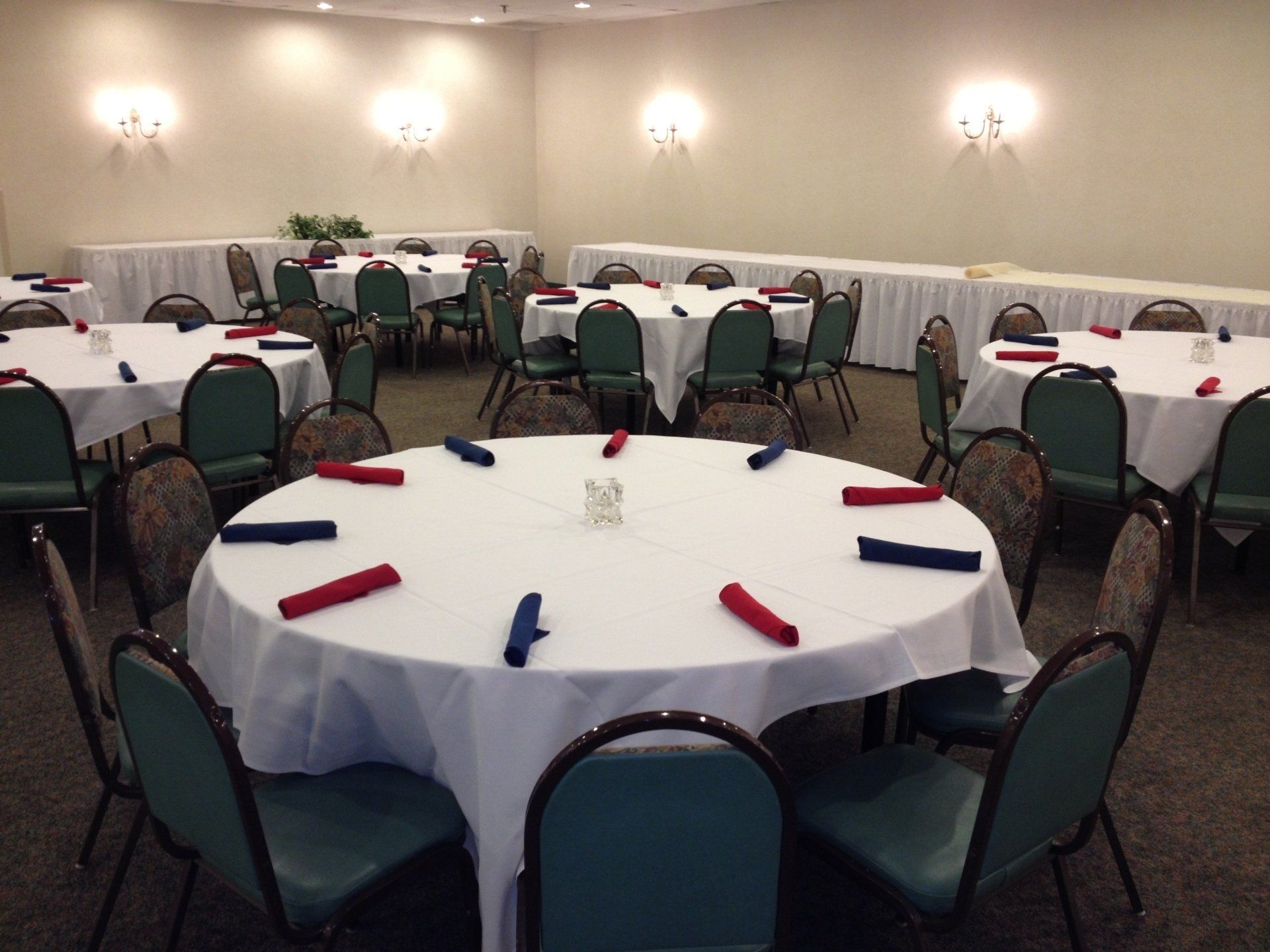 A room with tables and chairs set up for a party