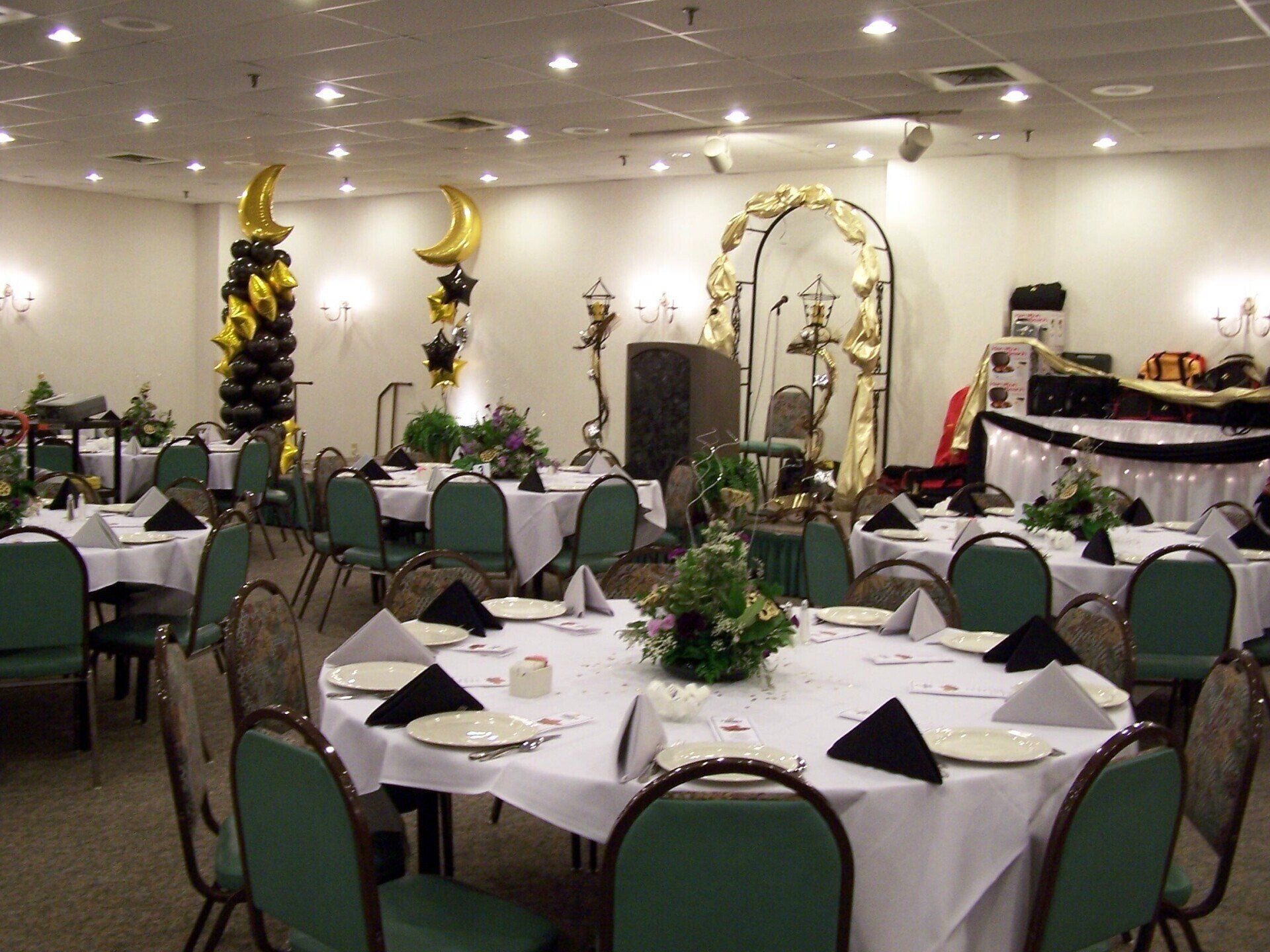 A large room with tables and chairs set up for a party