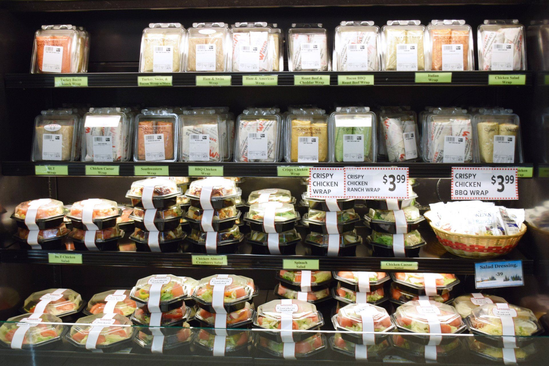 A grocery store shelf with jars of food and a sign that says $ 3.99