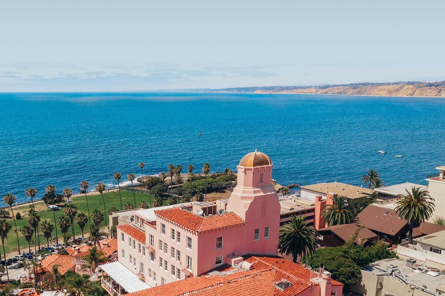 The historic pink La Valencia Hotel overlooking the Pacific Ocean coastline in La Jolla, California.
