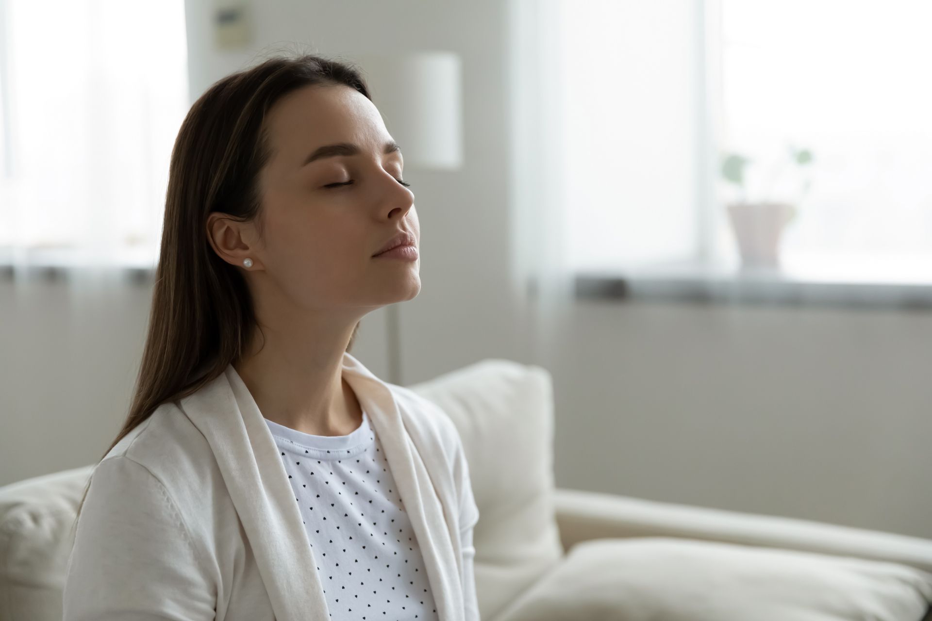 A Woman is Sitting on a Couch