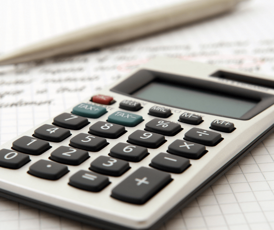 Calculator on lined paper with a pen in the background. Calculator on lined paper with a pen in the background.