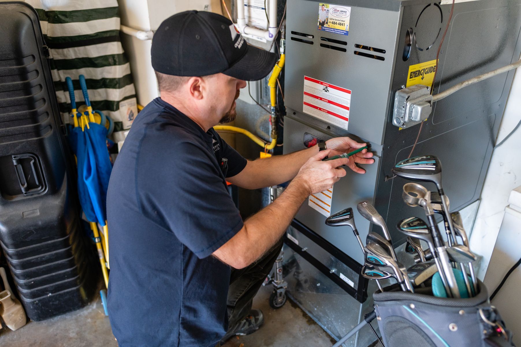 Technician adjusting controls on industrial equipment in a workshop