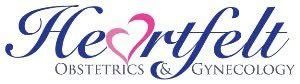 Logo for Heartfelt Obstetrics & Gynecology, featuring the brand name in navy script with a pink heart replacing the ‘a’.