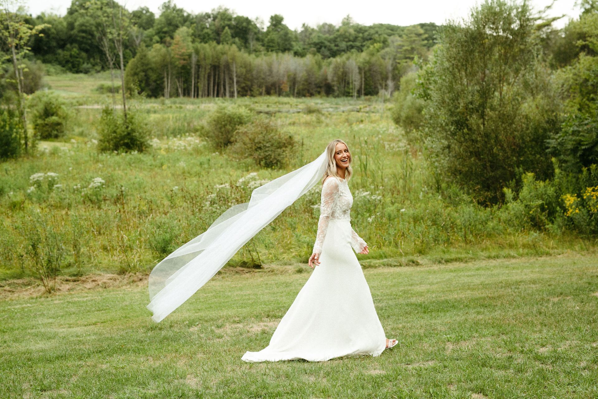 A bride takes photos at Whispering Springs