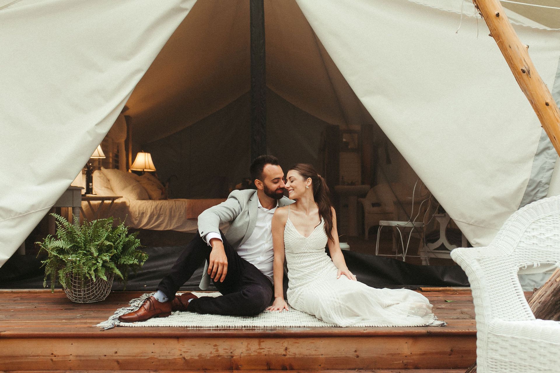 Bride and groom at forest wedding glamping tent at Whispering Springs