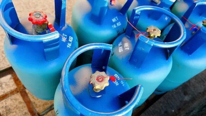 Pressurized Tank — Lewisville, TX — AAA Recycling, Inc. Blue propane tanks with red and yellow valves, grouped together outdoors.