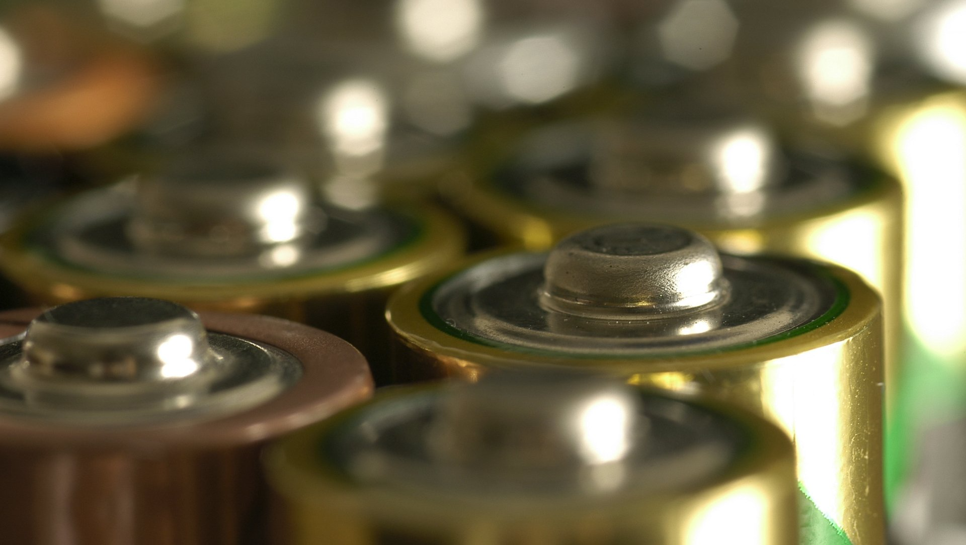 Broken Batteries — Lewisville, TX — AAA Recycling, Inc. Close-up of several AA batteries, gold and brown, with silver positive terminals.