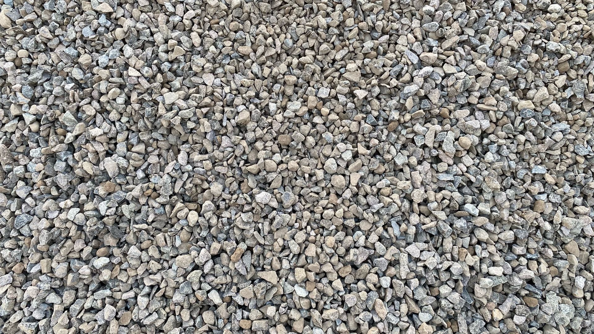 Close-up of gray and tan gravel stones filling the frame