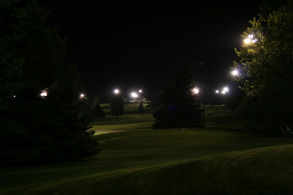 A park at night with lots of lights and trees