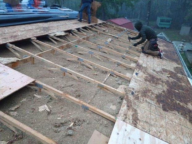 Professional roof repair in progress on a residential home to restore damaged roofing before new materials are installed