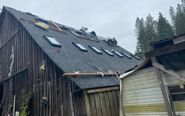Asphalt shingle roof replacement completed on a residential barn by Washington Infinity Roofing