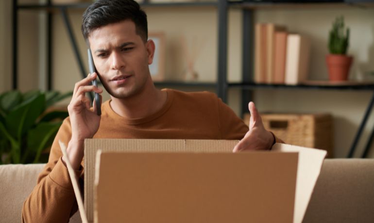 Disappointed customer on the phone at home with an open box shipment