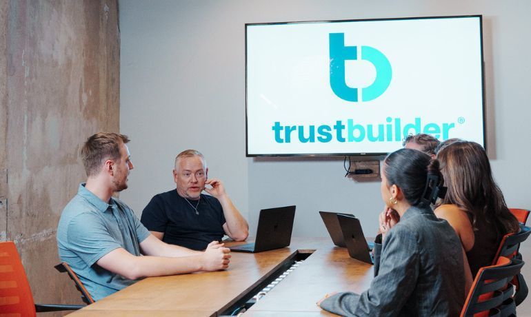 A group of people sitting in a conference room with a consultant
