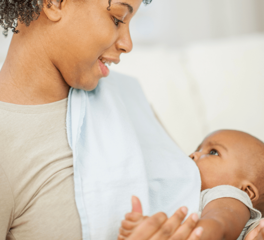 Mother feeding a baby with milk formula in a bottle