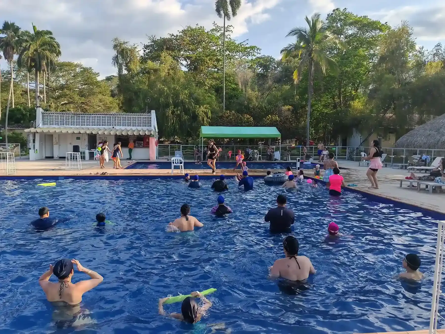 Personas disfrutando de una piscina al aire libre en Villeta, una opción de planes para hacer en Villeta.