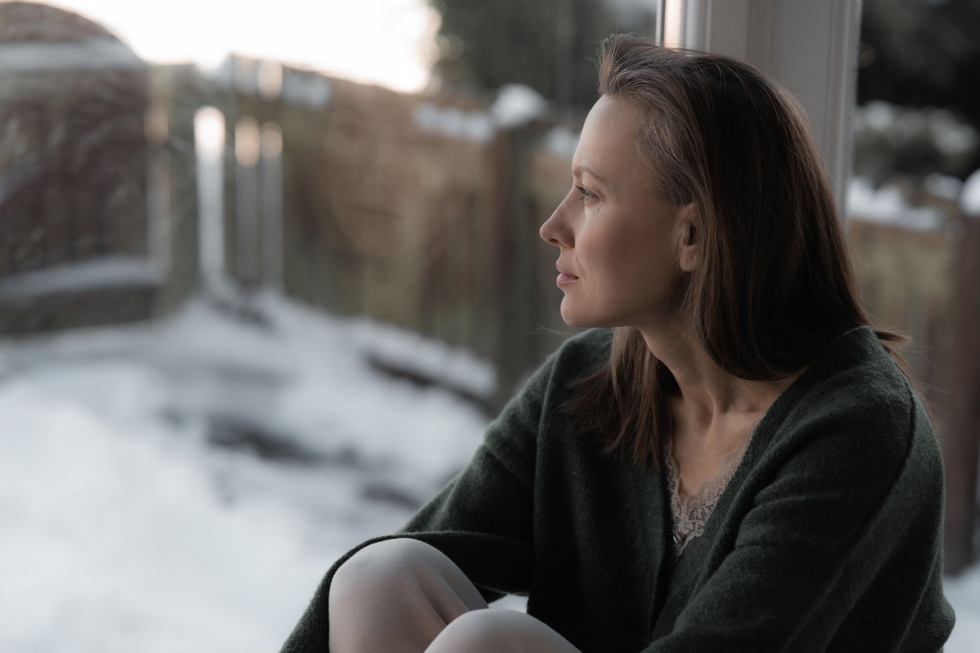Woman looking out window.