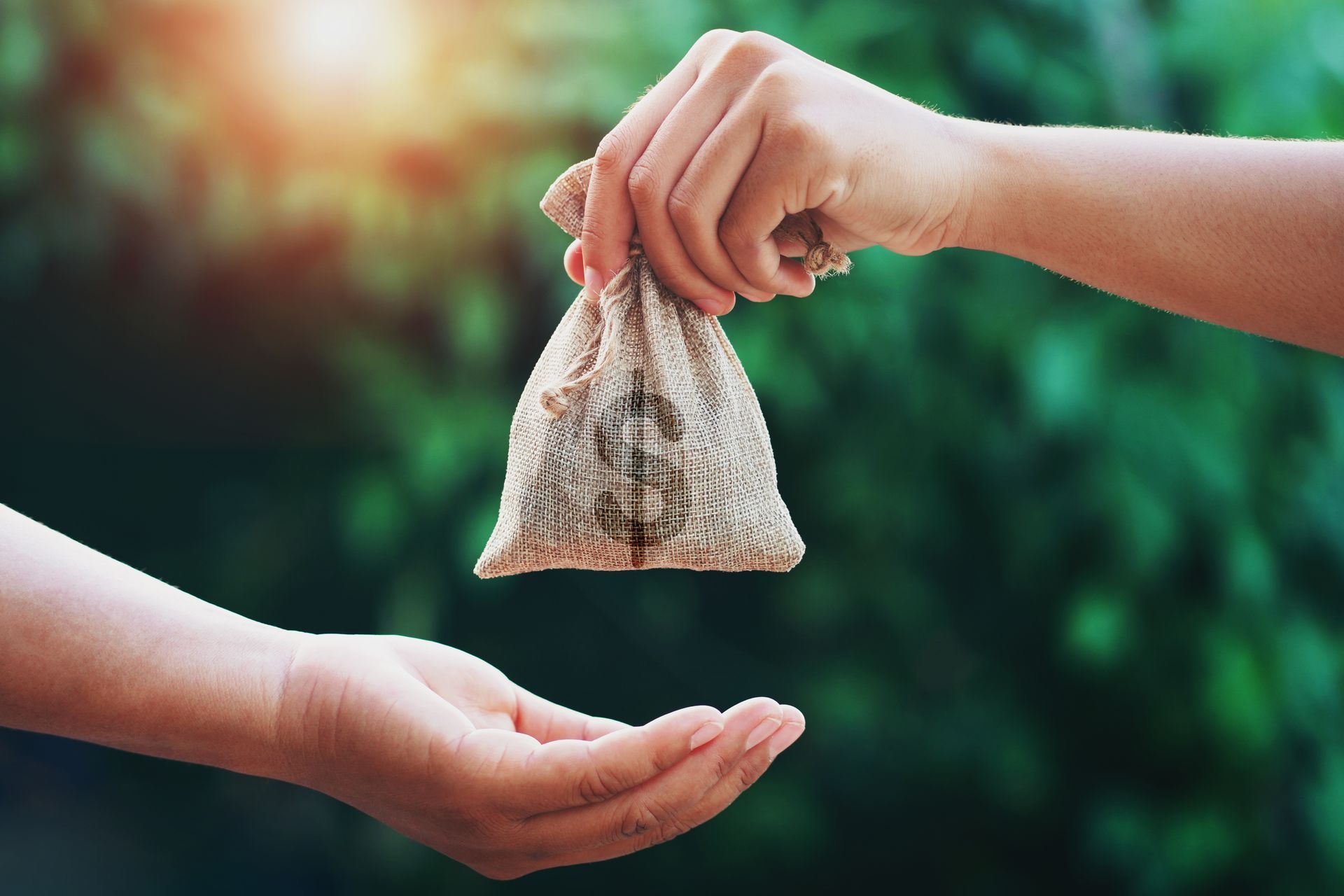 A person is handing a bag of money to another person.
