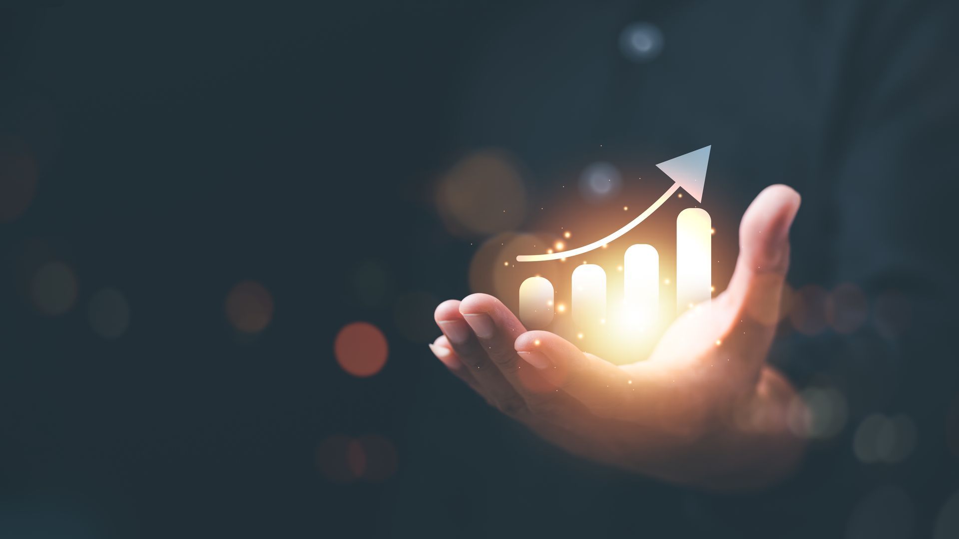 A person is holding a glowing graph in their hand.