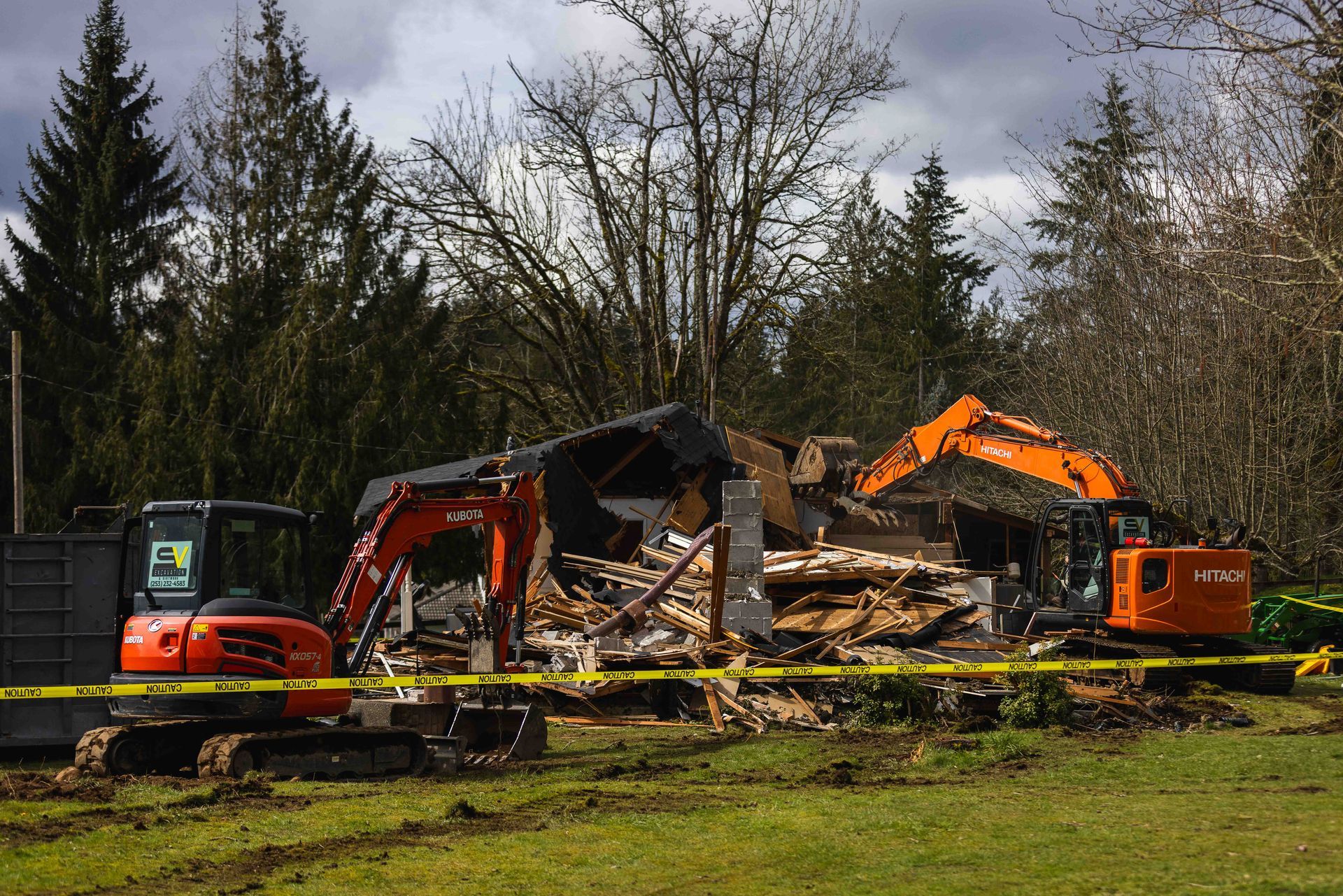 A demolition site with a yellow tape surrounding it