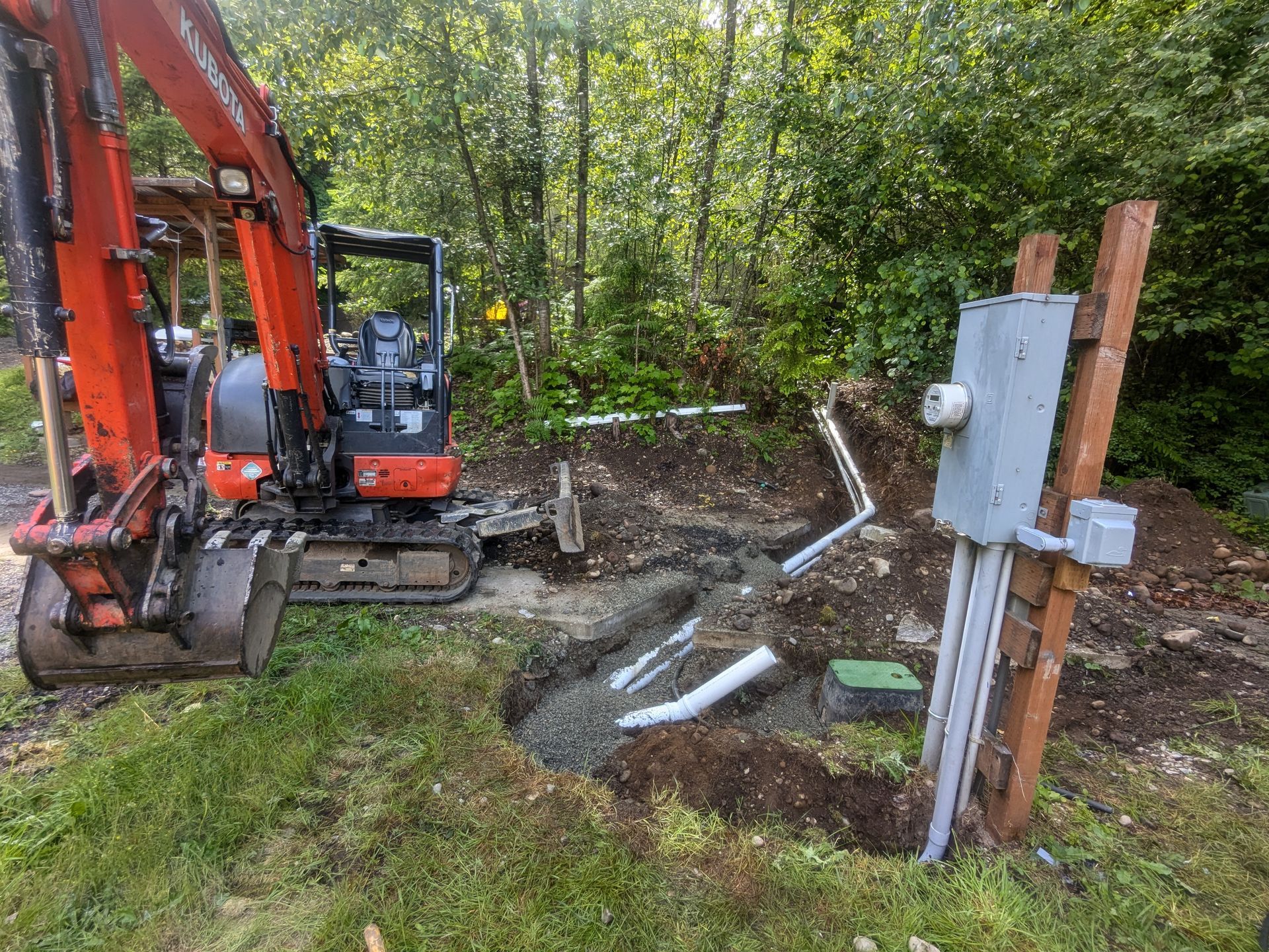 A small excavator is digging a hole in the ground.