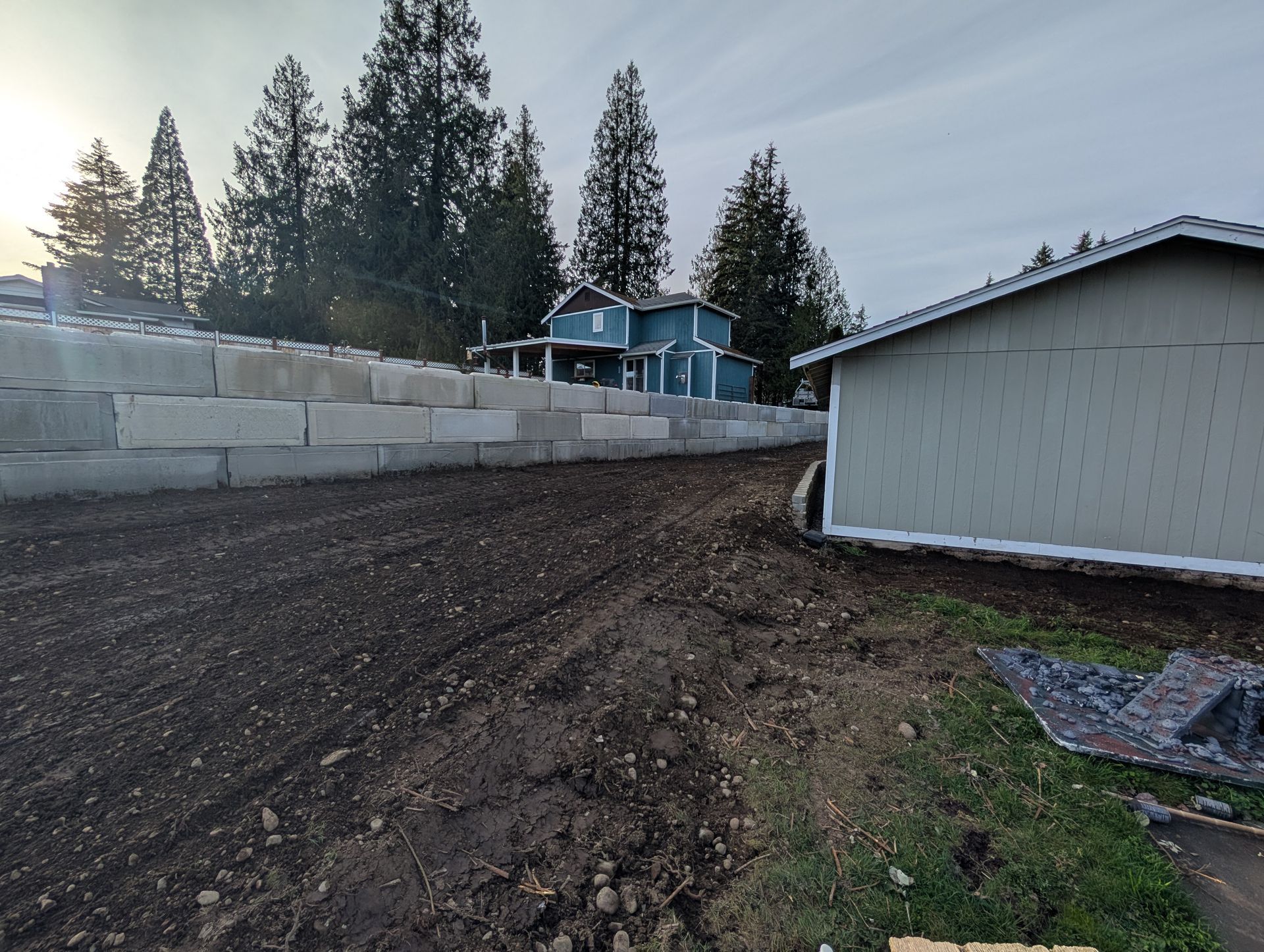 A house is being built on top of a dirt hill.