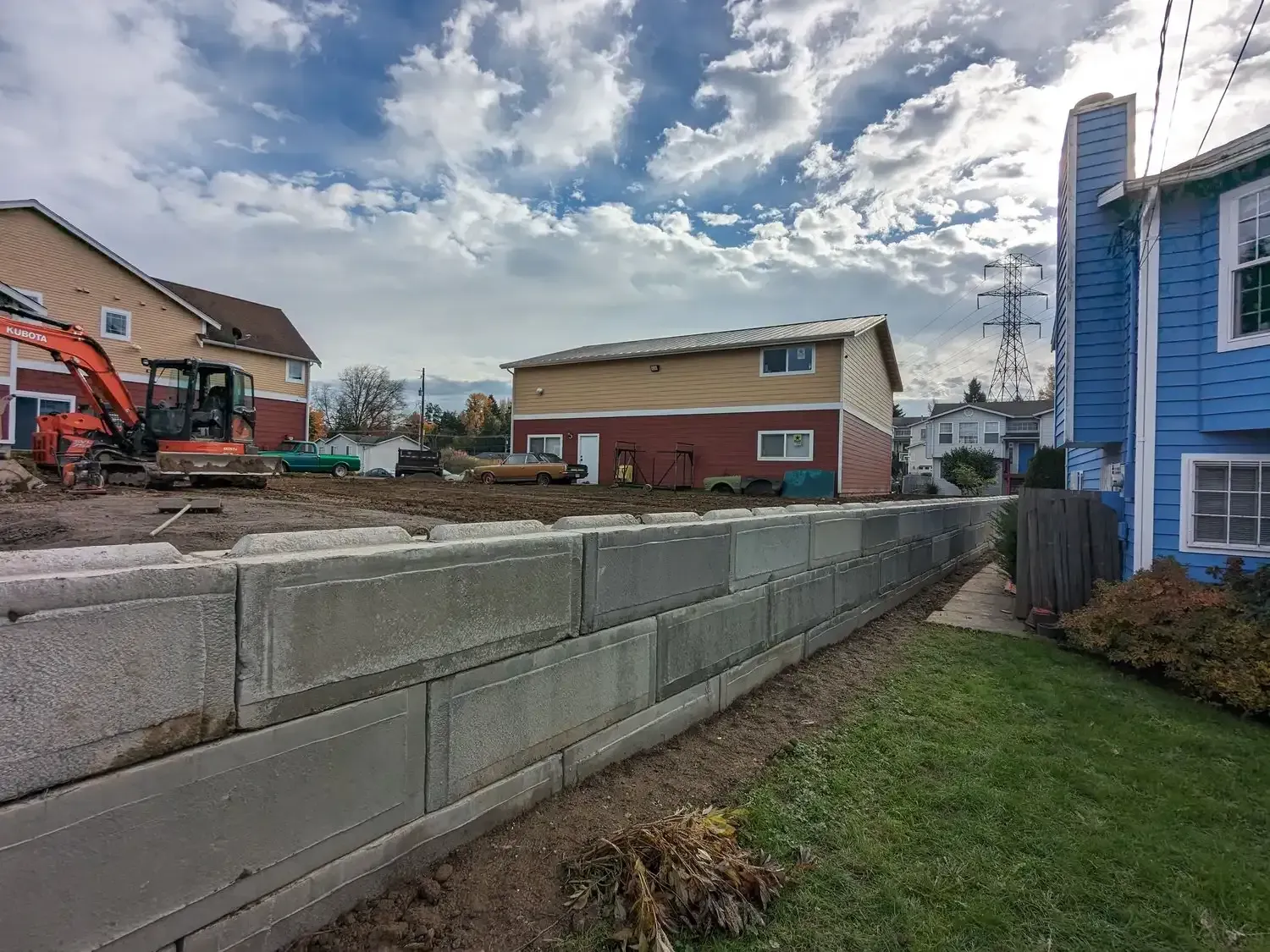 A concrete wall is being built in front of a house.