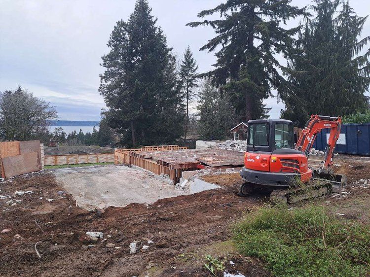 An excavator is sitting in the middle of a construction site.