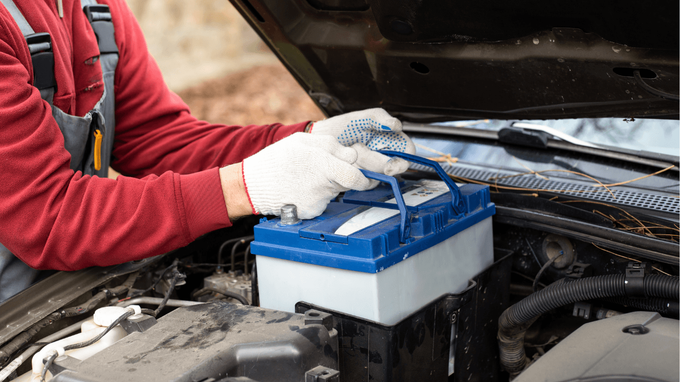 a mechanic doing a battery change
