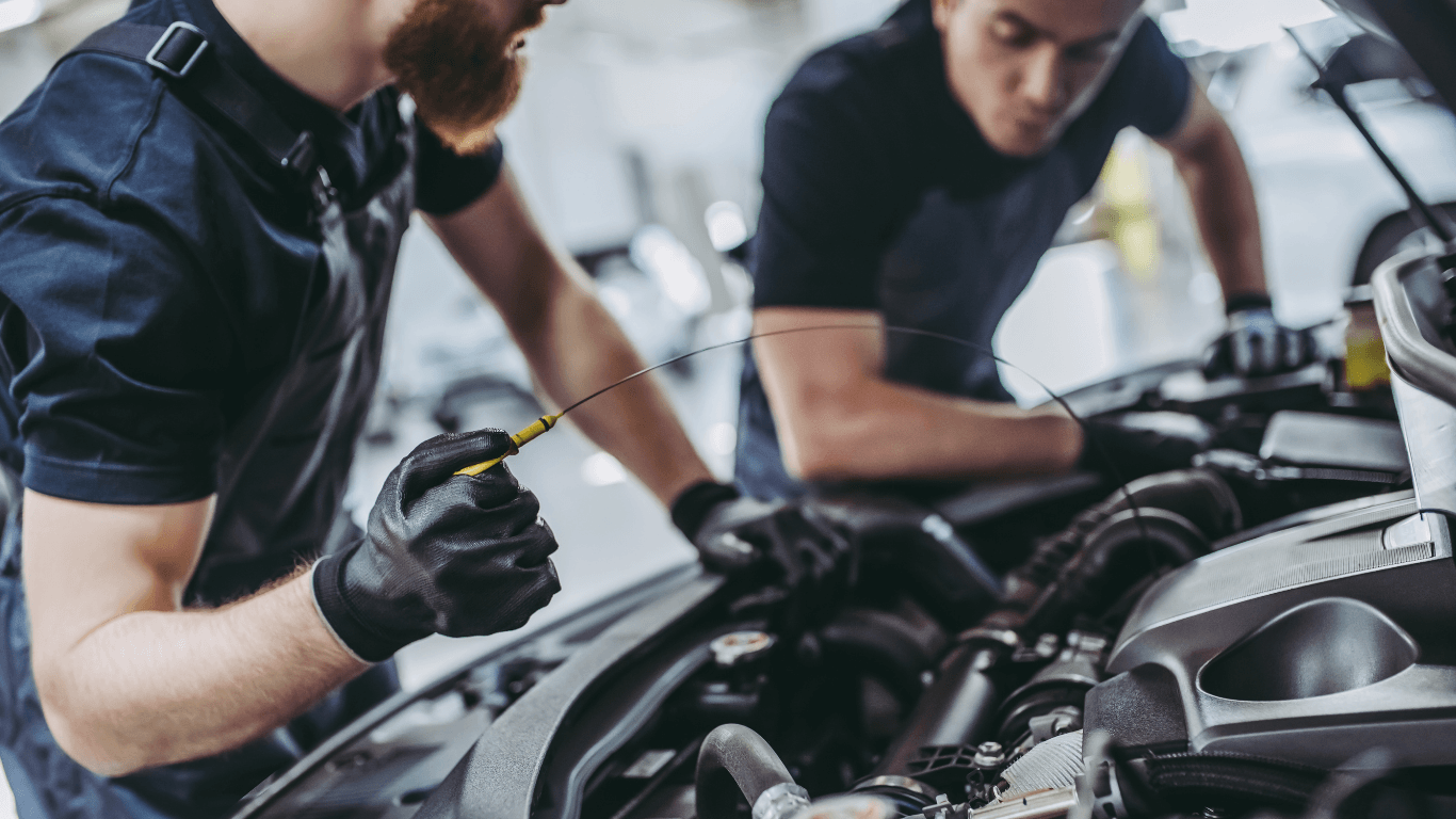 two mechanics doing a mobile oil change